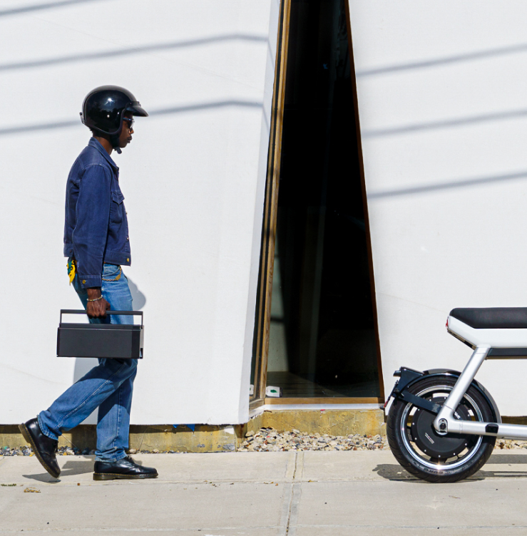 Person walking next to an electric bike